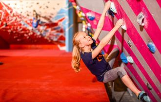 Children climbing boulders wall