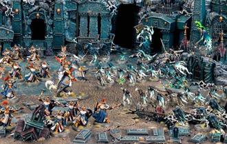 Scene filled with Warhammer models.