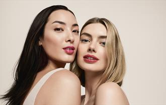 Two model close up showcasing clarins lip oil