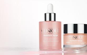 Clinique moisture surge serum bottle next to clinique moisture surge bottl
