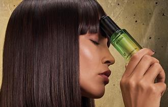 Model holding an aveda product