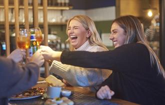 Group of ladies at PizzaExpress saying cheers