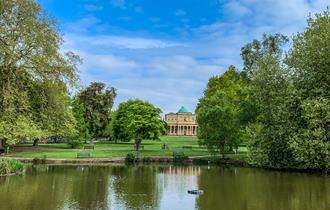 Pittville Pump Room Cheltenham across the lake