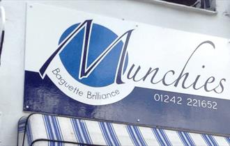 Munchies shopfront showing the blue and white Munchies logo