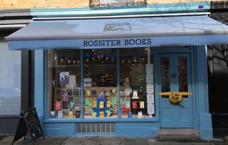 Traditional shop from of Rossiter Books with large window and awning