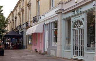 The Tonic salon traditional style shopfront in pale green painted wood.