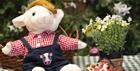 A teddy lamb and decorated wooden farm