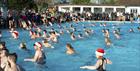 Swimmers wearing Santa hats