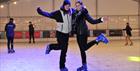 People skating on the ice rink.