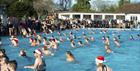 Swimmers wearing Santa hats