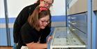 Mum and daughter exploring the drawers at the Museum of Gloucester