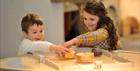 Two children enjoying the Museum of Gloucester's interactive learning activities