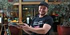 Nandos team member holding Nandos food