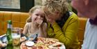 A family enjoying pizza