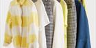 Selection of colourful clothes hanging on a rack