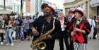 Live performance and crowds at Cheltenham High Street.