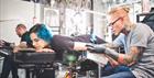Woman having her arm tattooed