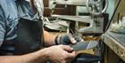 Timpson worker resoling a shoe.