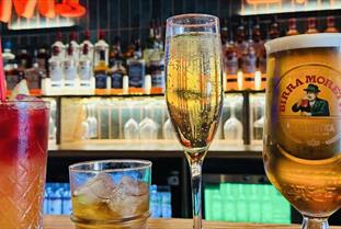 Two cocktails, a flute of champagne and a pint of beer on the bar at The Miller Cheltenham