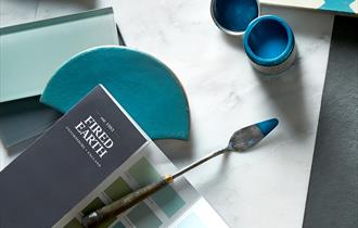 Paint swatch surrounded by colourful house accessories