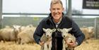 Adam Henson holding 2 lambs