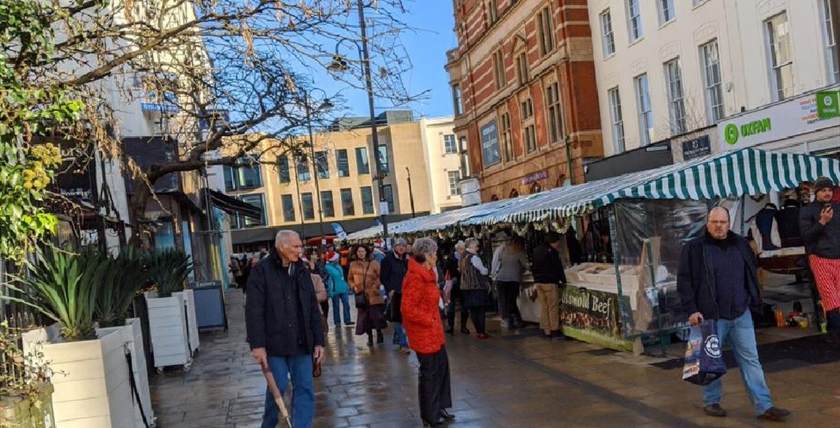 People visiting a Christmas market in Cheltenham.