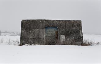 A metal shelter in a snowstorm