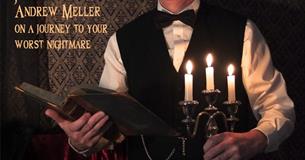 Andy Meller dressed as a butler holding a candle