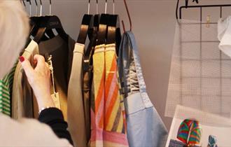 Women looking through a rack of clothes