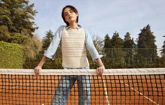 Model wearing Hobbs clothing on a tennis court