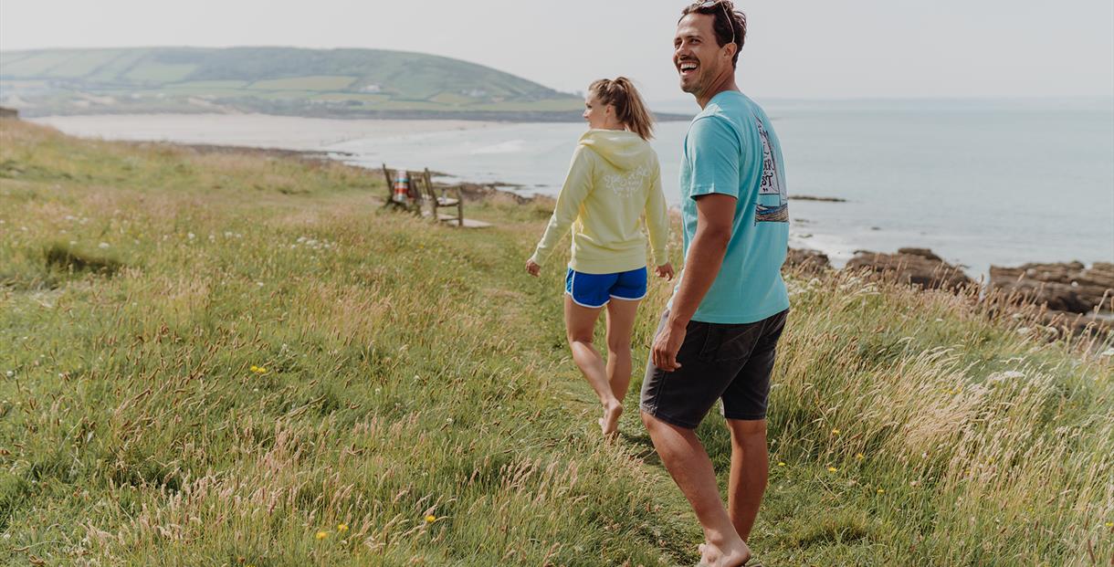 A young couple overlooking the Devon coast