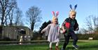 2 children wearing bunny ears running around Sudeley Castle & Gardens