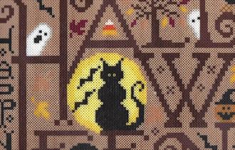 A craft bead image of a cat and bats