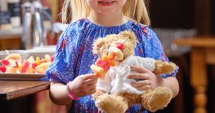 Child holding a teddy bear.