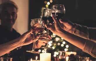 A group of people raise a toast with glasses of wine