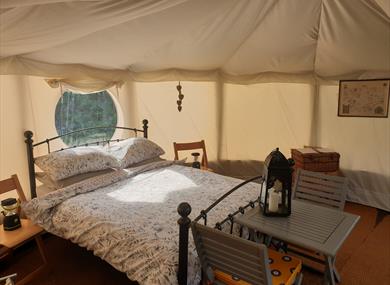Bed inside a Yurt at Tipsy Tree Glamping