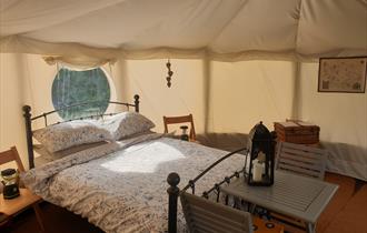 Bed inside a Yurt at Tipsy Tree Glamping