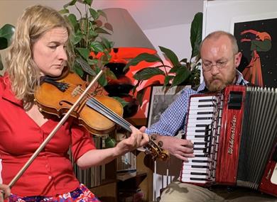 Adam Fairhall playing accordion and Olivia Moore playing violin
