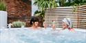 Relax in an outdoor hot tub at Cottons Hotel & Spa