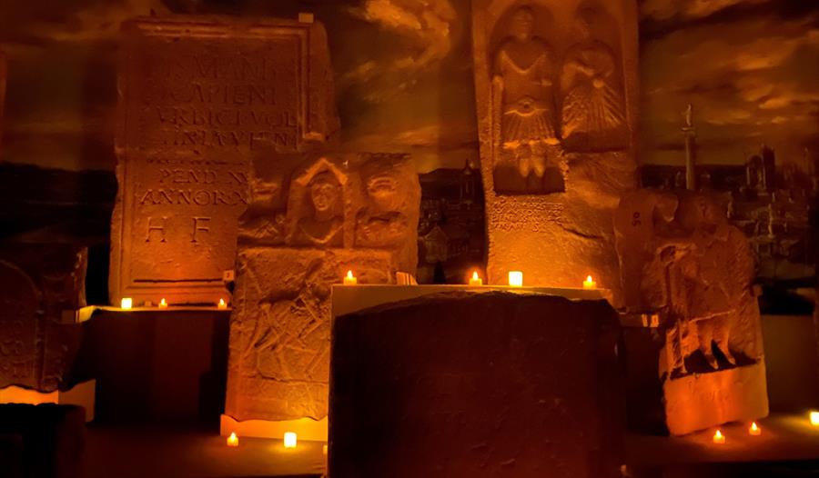 Roman stones gallery lit up by candle light