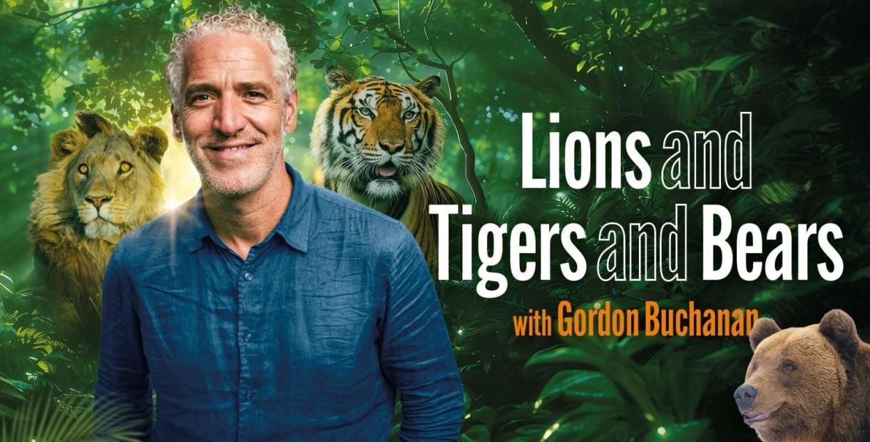 Gordon Buchanan standing in front of trees and a lion, tiger and bear