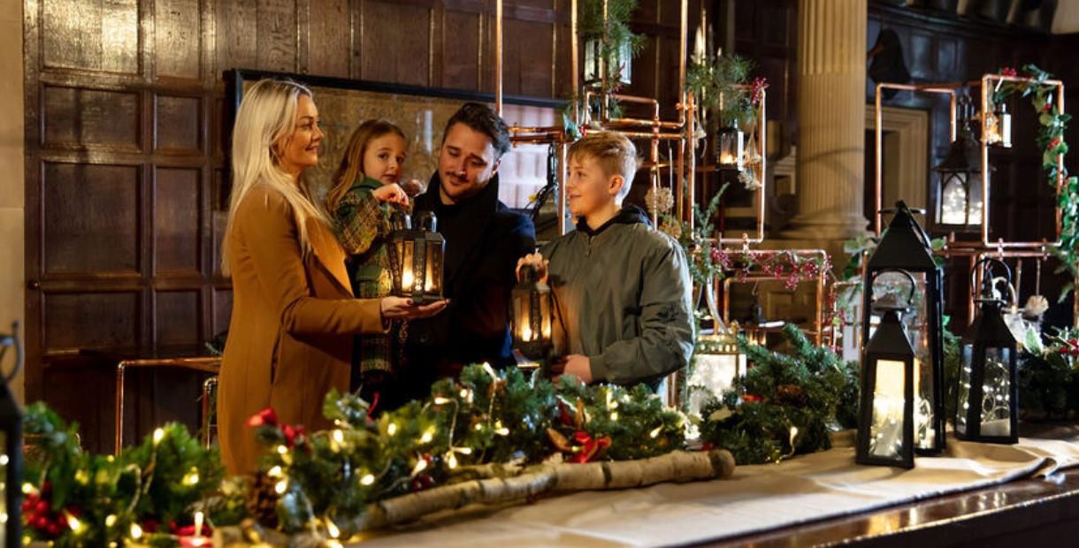 Family gathered around a Christmas tablescape with their lanterns at Hardwick.