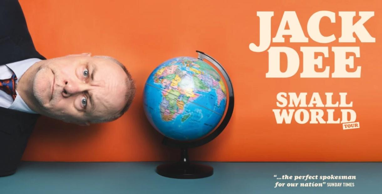 Jack Dee sideways next to a globe