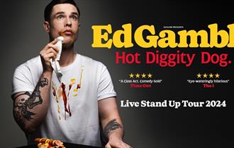 Ed Gamble wiping hot dog sauces off his face with a napkin