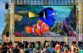 Finding Nemo film playing on outdoor cinema screen with crowds watching