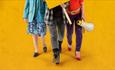 The legs of three women who are holding a sign and megaphone