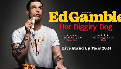 Ed Gamble wiping hot dog sauces off his face with a napkin