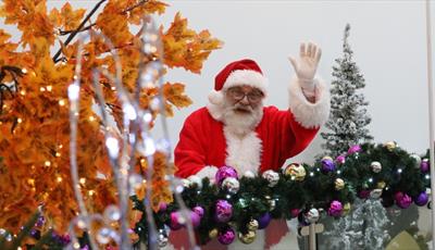 Father Christmas waving at the camera 