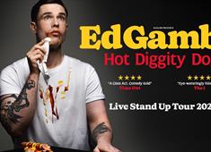 Ed Gamble wiping hot dog sauces off his face with a napkin