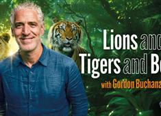 Gordon Buchanan standing in front of trees and a lion, tiger and bear